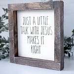 Angled View of the Joshua Jar Just a Little Talk With Jesus Makes it Right wood sign against a white backdrop and greenery